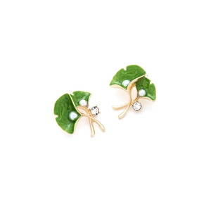 Detail of gold ginkgo leaf earrings with green enamel, faux pearls and crystals