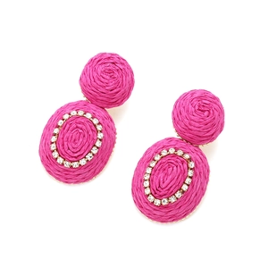 Macro detail of hand-woven fuchsia raffia earrings with sparkling crystal accents