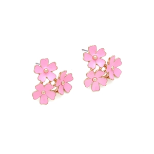 Detail of pink enamel triple flower earrings with golden accents and petal textures