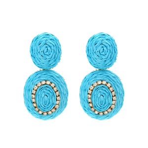Detail of sky blue woven raffia earrings with sparkling rhinestone crystals and beads