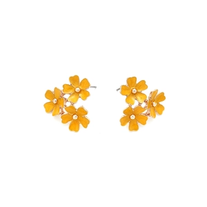 Close-up of yellow enamel flower earrings with golden centers and triple petal design
