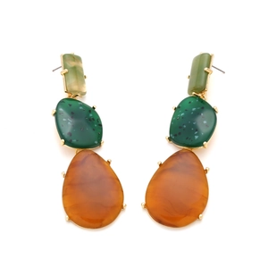 Detail of geometric resin drop earrings featuring green and amber marbled splash texture