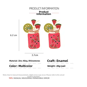 Detail of colorful juice glass earrings featuring watermelon slices and pink rhinestones