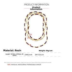 Detailed view of bohemian style layered resin bead necklaces in brown, cream, and gold tones