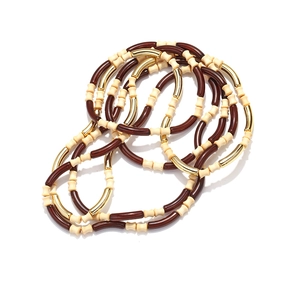 Detail of multi-layered bohemian beads necklace with wood resin and gold metal accents