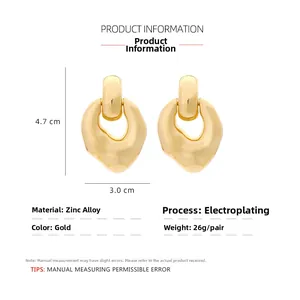 Detail view of gold alloy drop earrings with 4.7cm height and 3.0cm width dimensions