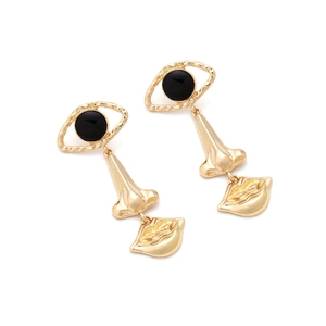 Close-up of gold alloy earrings featuring artistic eye, nose, and lip charms