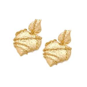Macro detail of gold textured heart earrings featuring a layered chain wrap design