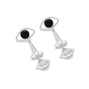 Detail of surrealist silver earrings featuring artistic eye, nose, and lip motifs