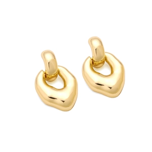 Detail of gold organic earrings with irregular geometric shapes and mirror finish