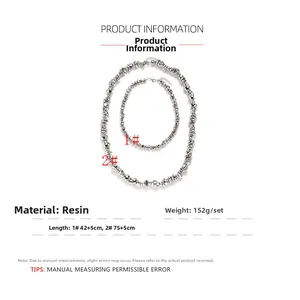 Detail view of silver resin beaded necklaces with irregular lava texture and dimensions