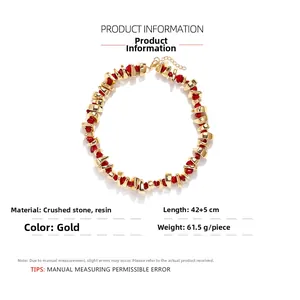 Detail showing red resin beads and golden metal nuggets with a 42+5cm lobster clasp