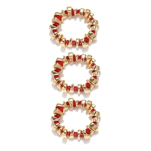 Detailed view of handmade bohemian bracelets featuring gold metal blocks and red resin stones