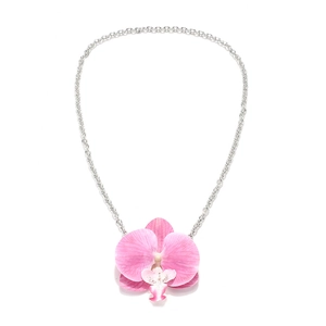 Realistic pink orchid petal pendant necklace with silver chain on white background