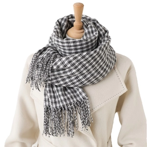 Classic black and white checkered plaid scarf with fringes on a mannequin for autumn winter