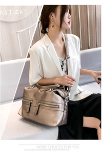 Detail of bronze metallic PU leather tote bag with functional zippers and adjustable strap