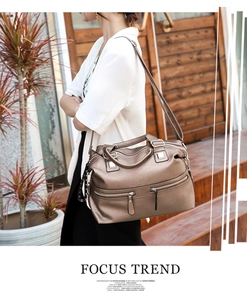 Detail of soft leather tote bag with functional zippers and silver hardware in bronze