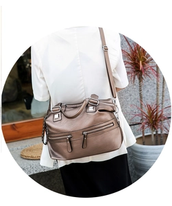 Detail view of large soft leather tote bag with zip pockets and adjustable strap