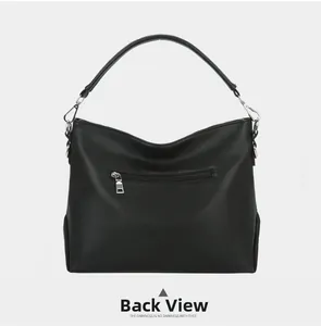 Detailed back view of black lychee leather handbag showing sturdy zipper pocket and texture