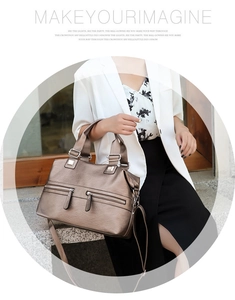Detail view of metallic bronze hobo bag with litchi texture and functional silver zippers