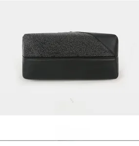 Detailed bottom and side view of black evening bag with silver rhinestone embellishments