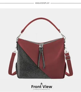 Detailed view of burgundy pebbled leather handbag with rhinestone polka dots and tassel