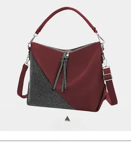 Detail of red crossbody bag with lychee grain texture and sparkling rhinestone accents