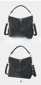 Detail view showing rhinestone embellishments and tassel zippers on the dark tote bag