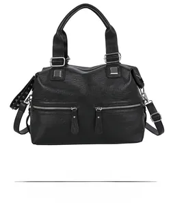 Detailed front view of black leather tote bag featuring dual silver zippers and studs