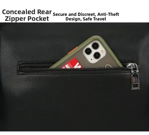 Detail of a hidden back zipper pocket on a black pebble leather tote bag with a smartphone
