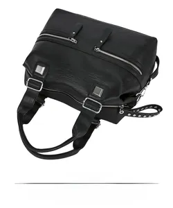 Close-up of black lychee texture leather tote with silver zippers and rivet details