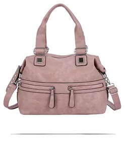 Front view of pink faux leather handbag with dual zipper pockets and silver metal hardware