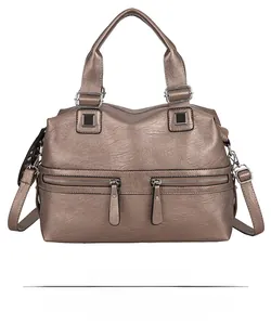 Detailed front view of bronze faux leather tote with textured finish and zipper pockets