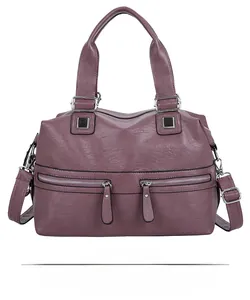 Detailed front view of a purple soft leather tote bag with silver zipper accents