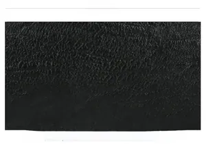 Close-up of black leather texture with natural lychee grain and soft matte finish