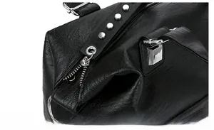 Detail view of smooth silver zipper and litchi texture on black leather tote bag