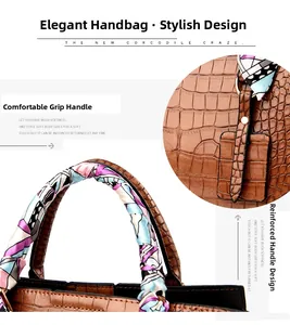 Detailed view of crocodile pattern embossed handbag with reinforced handle and silk scarf