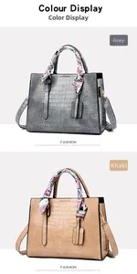 Detail of gray and khaki embossed crocodile leather handbags with decorative scarves