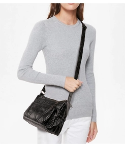 Detail view of the black multi-zippered crossbody bag with a vintage washed texture