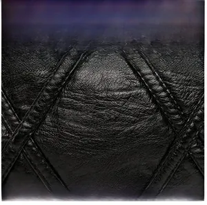 Close-up of black PU leather bag showing diamond quilted stitching and lychee texture