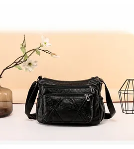 Detail view of black soft PU leather bag featuring quilted stitching and multiple zippers