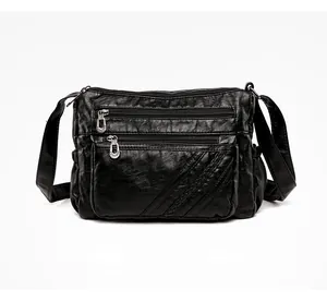 Detail view of black PU leather bag with multi-zipper pockets and woven decorative lines
