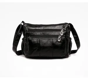 Detailed front view of black soft PU leather crossbody bag with multiple zipper pockets