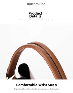 Détail de la poignée ergonomique en cuir marron avec finition des bords et coutures noires