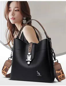 Detail of black cowhide bucket bag with silver chain buckle and jacquard shoulder strap