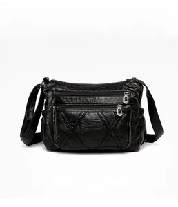 Detailed front view of black PU leather crossbody bag with multiple zipper pockets