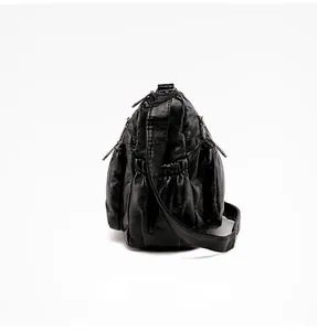Detailed side view of black soft leather multi-zip bag with textured vintage finish