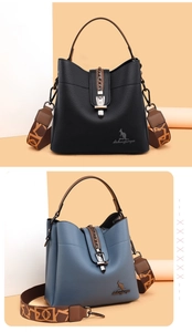 Detailed view of lychee grain leather bucket bag with jacquard strap and metal buckle