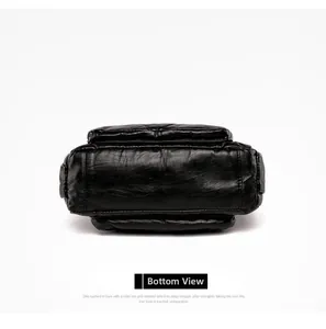 Detailed bottom view of soft black PU leather bag showing stitching and wide base