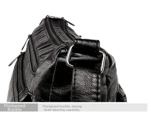 Close-up of thickened silver metal buckle on black lychee grain leather shoulder bag